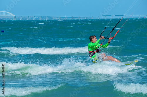 Kite surfing on the blue sea in the background of blue sky at summer time. Kiteboarding. Fun in the ocean. Extreme Sport , surfing man