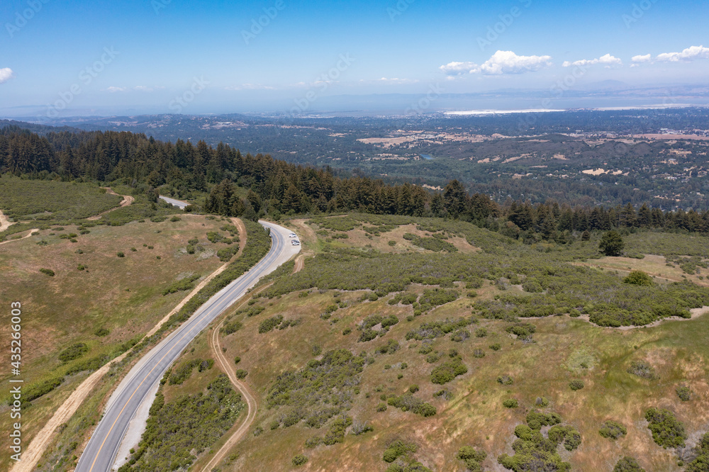 A scenic road meanders through the vegetation-covered hills of the East Bay, just a few miles from San Francisco Bay in Northern California. This area provides open spaces for hikers and bikers. A scenic road meanders through the vegetation-covered hills of the East Bay, just a few miles from San Francisco Bay in Northern California. This area provides open spaces for hikers and bikers.