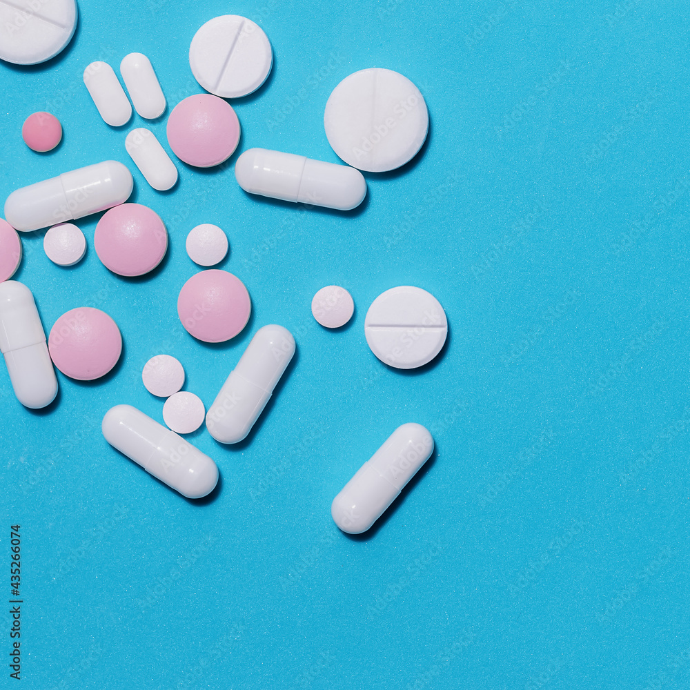 tablets, vitamins and dietary supplements on a blue background .