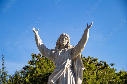 Imagem de santo com vegetação e céu azul ao fundo. Imagem que fica em frente à Igreja Nossa Senhora da Assunção em Goiânia.