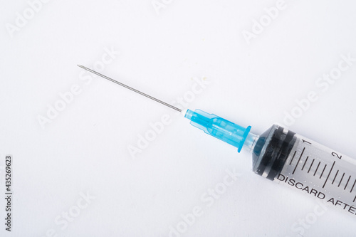 Dirty used plastic syringe, isolated