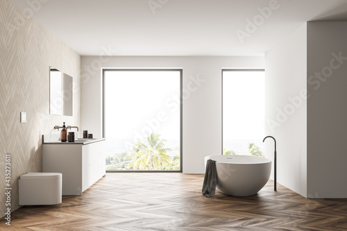 Spacious modern bathroom design interior in wood tones with parquet floor  freestanding tub  double sink vanity. Panoramic window.