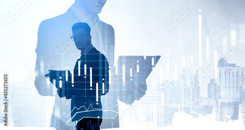 Bilde på lerret Two young business people researching financial data based on reports