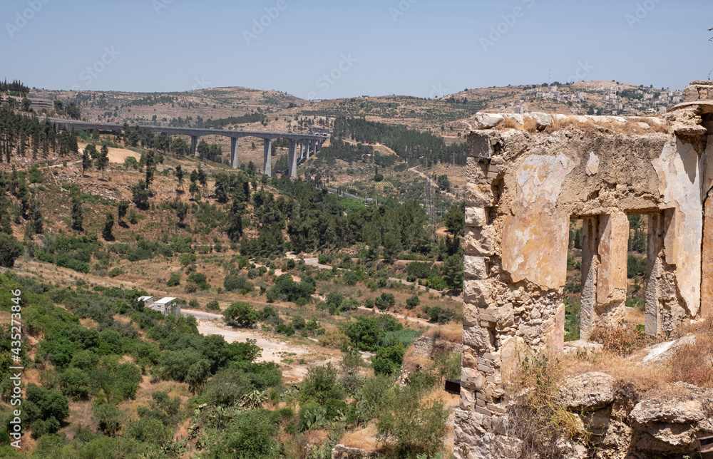 View on a modern railway bridge for fast trains connecting Jerusalem with Tel-Aviv from an a abandoned Arab village Lifta on the outskirts of Jerusalem. National nature reserve Lifta.