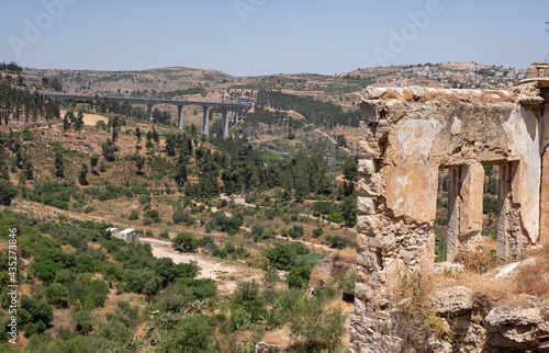 View on a modern railway bridge for fast trains connecting Jerusalem with Tel-Aviv from an a abandoned Arab village Lifta on the outskirts of Jerusalem. National nature reserve Lifta.
