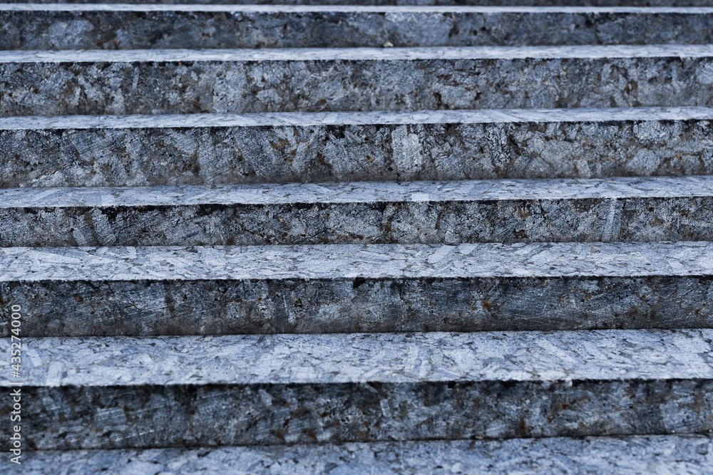 Small steps of unpolished gray stone close-up