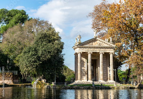 view from across the lake at the Temple of Asclepius found in a park at the centre of Rome 