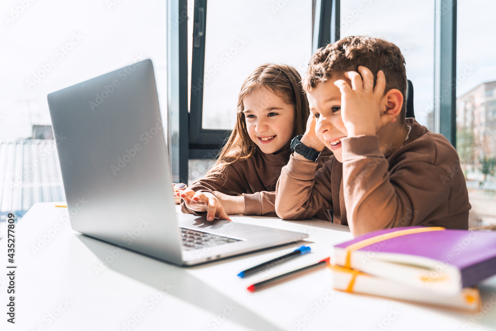 Boy and girl at laptop. Distance education Boy and girl at laptop. Distance education