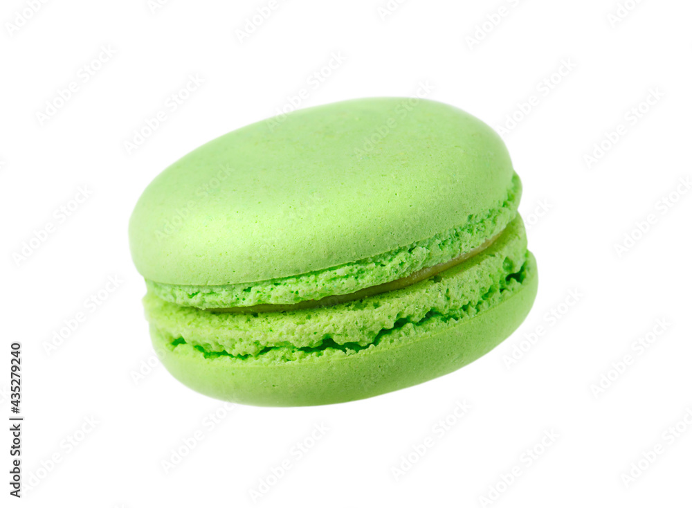 One green French cake isolated on white background. One green French cake isolated on white background.