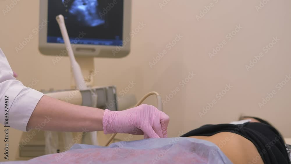 Health diagnostics. Work on an ultrasound diagnostic device, ultrasound examination. The sensor moves along the abdomen.