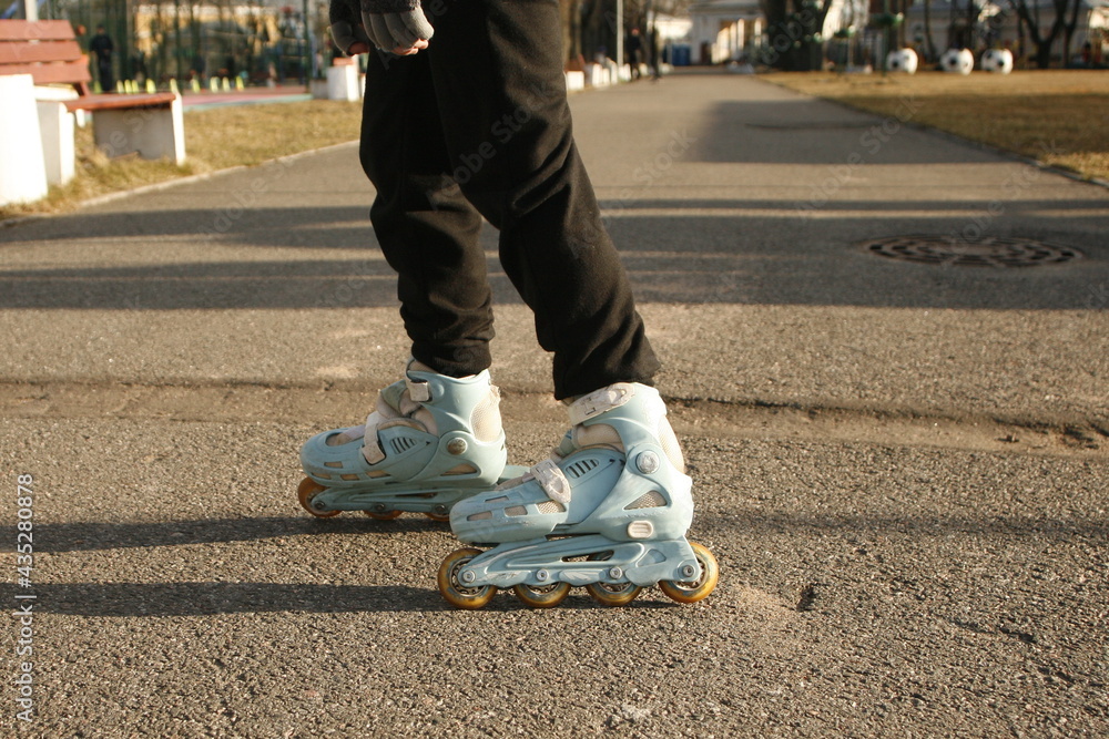 Fototapeta premium Legs of an unknown person in roller skates