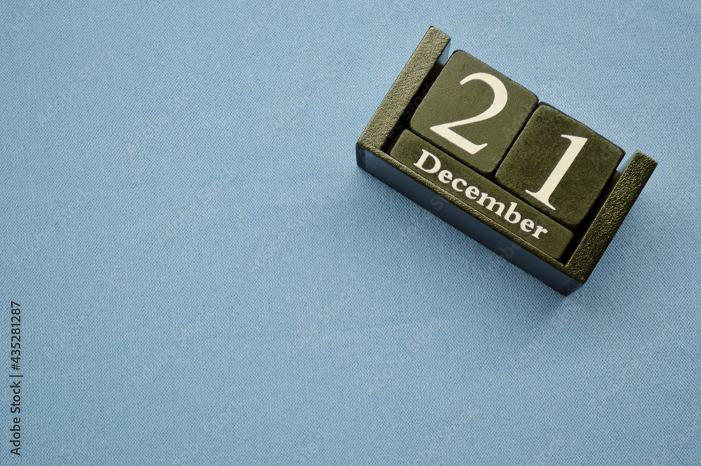 Wooden calendar from blocks on a blue background. Twenty first of December Wooden calendar from blocks on a blue background. Twenty first of December