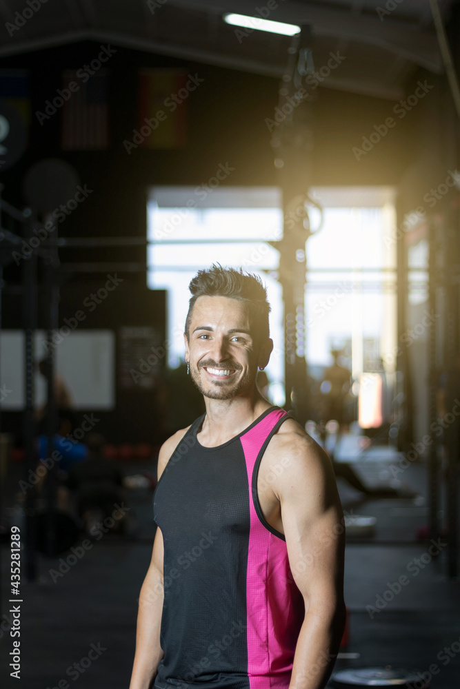
young man training inside a gym with functional exercise.
athlete body