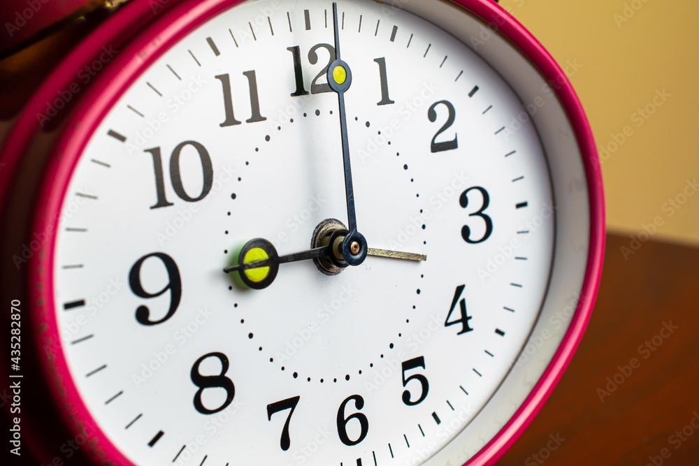 Mechanical hand clock white dial. Spring alarm clock. Mechanical hand clock white dial. Spring alarm clock.