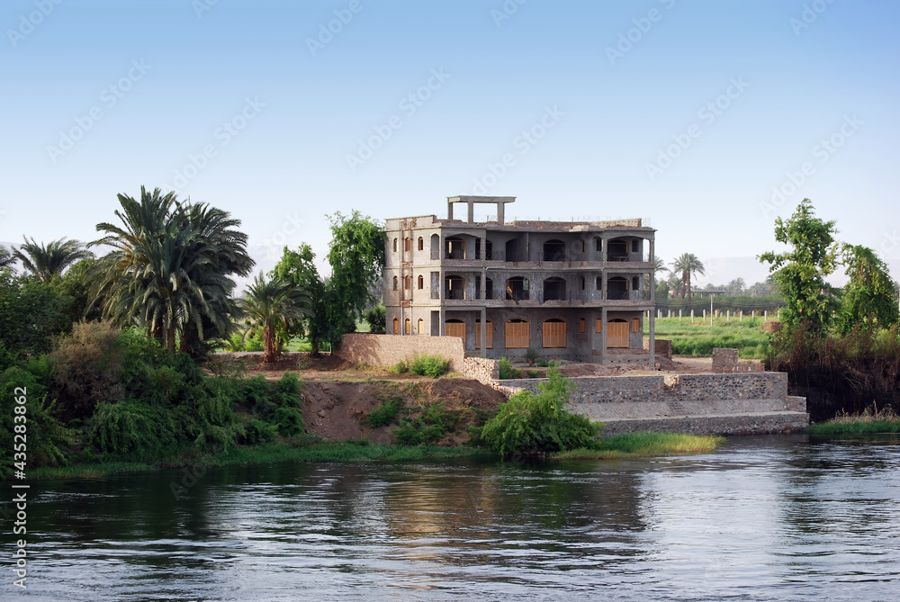 Building under construction on the Nile river shore. Southern Egypt, Africa. Cruising on Nile River.