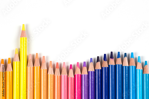 Colored pencils frame on white background. Top view. Learning, art, diversity, creative entertainment concept