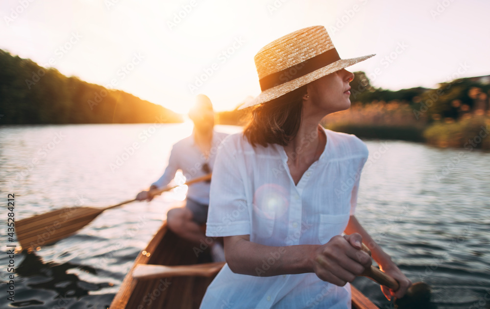 Enjoy paddling canoe on the sunset lake