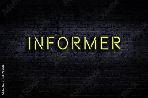 Photos Night view of neon sign on brick wall with inscription informer