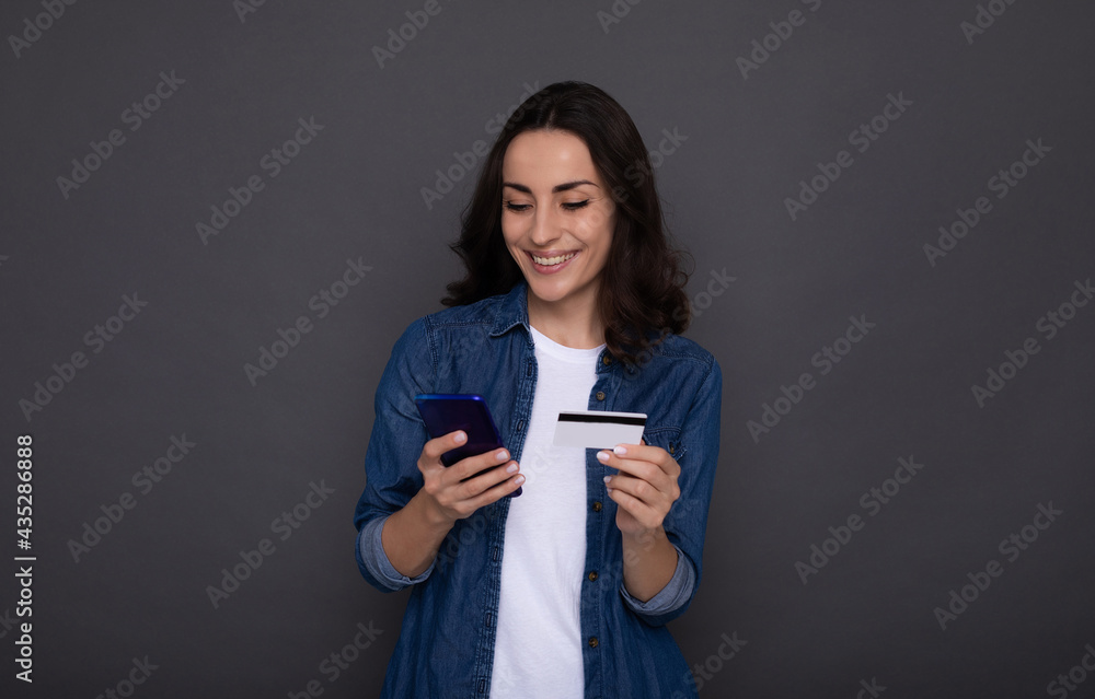 Young successful happy woman with a credit card in hand during online shopping Young successful happy woman with a credit card in hand during online shopping
