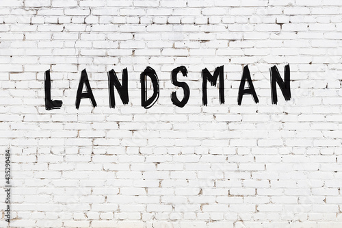 Inscription landsman painted on white brick wall photo