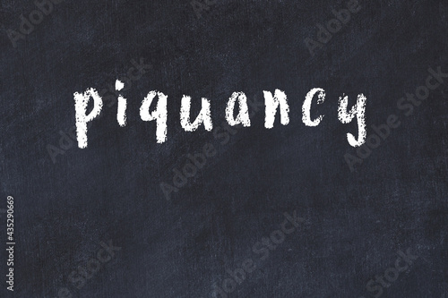 College chalk desk with the word piquancy written on in