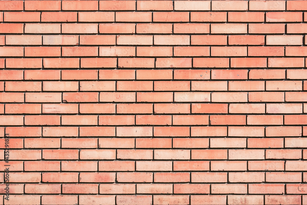 Red brick wall background outside of the building.