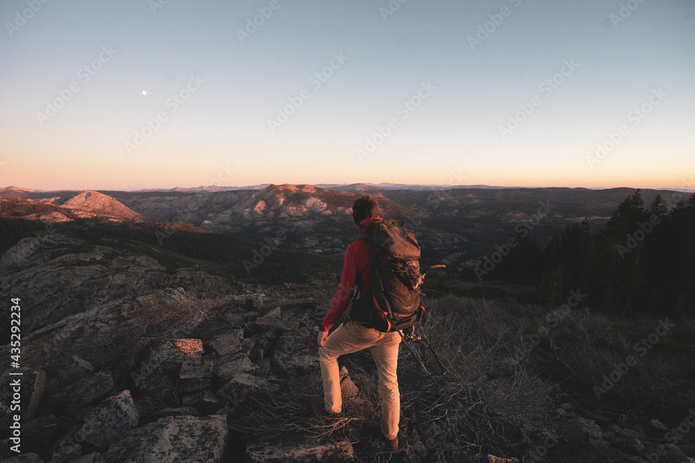 Fototapeta premium person standing on a cliff