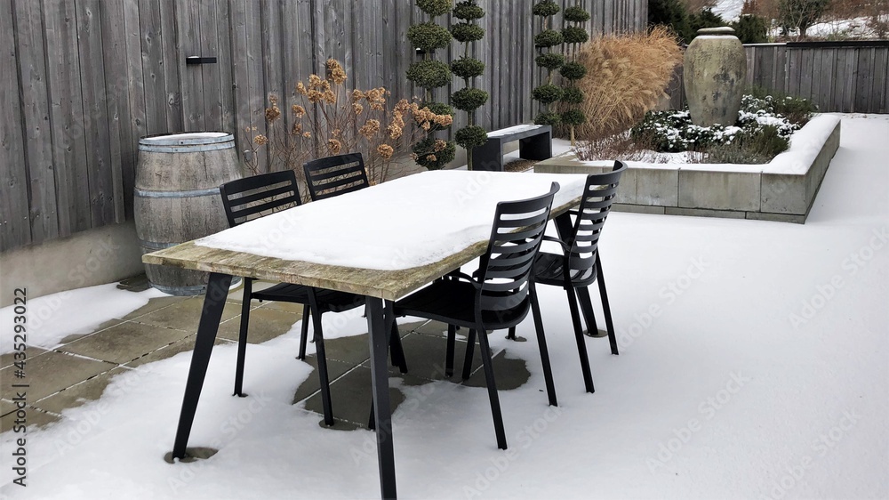 tables and chairs in snowy winter garden