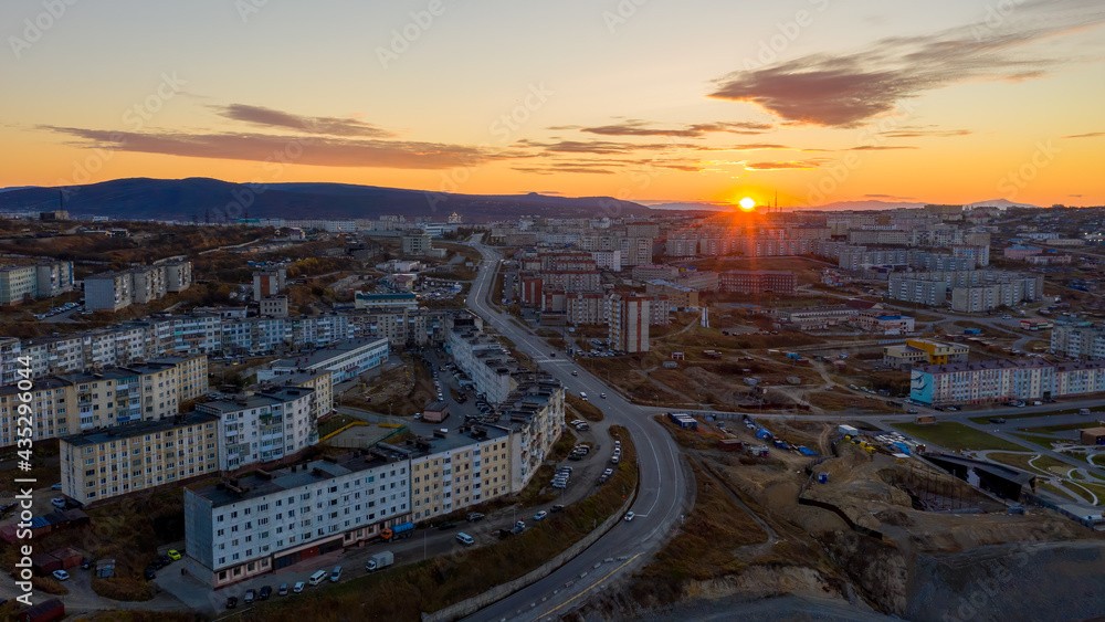 Panorama of the city of Magadan. Aerial view of sunrise over buildings and streets. Russian town in Asia. Morning city landscape. Magadan, Magadan region, Siberia, Far East of Russia.