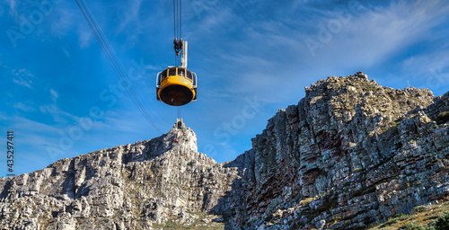 Table mountain yellow cable car with a view towards the top cable way station - Great outdoors adventure and travel holiday destination, Cape Town, South Africa