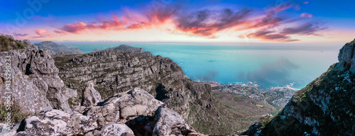 Table mountain from the top, looking out towards the Southern coastline with enhanced sunset sky - Great outdoors adventure travel destination, Cape Town, South Africa