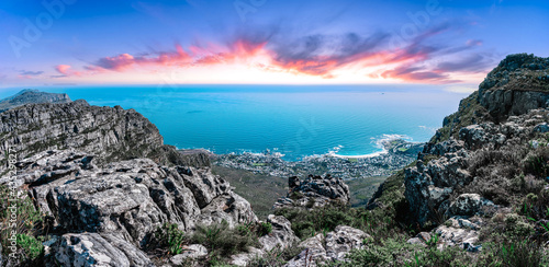 Table mountain from the top, looking out towards the Southern coastline with vibrant sunset sky - Great outdoors adventure travel destination, Cape Town, South Africa © Shawn