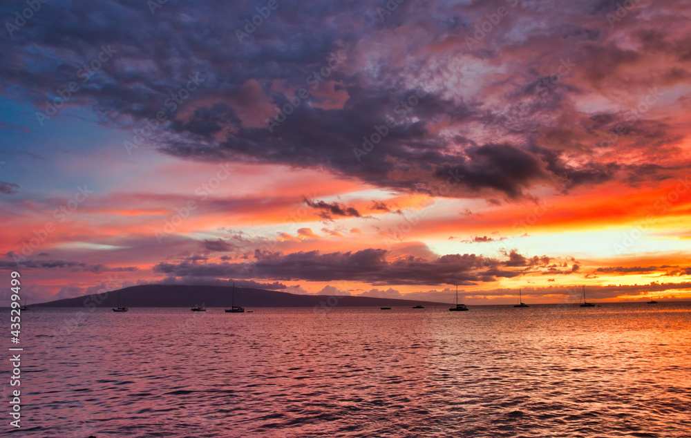 Naklejka premium Firey sunset sky with Lanai seen from Maui.