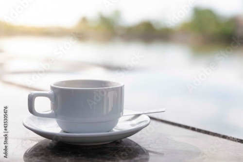 Coffee cups placed at the breakfast table by the river.