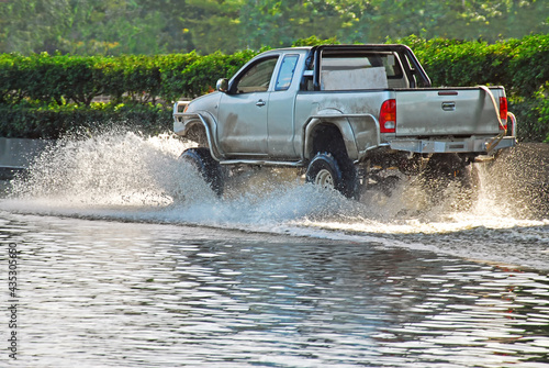 pickup truck  running through flood water