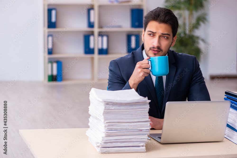 Young businessman employee and too much work in the office Young businessman employee and too much work in the office