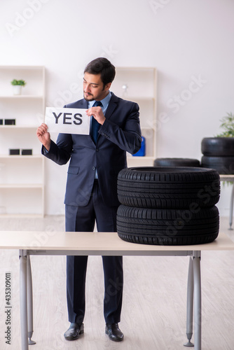 Young man selling tires in the office © Elnur