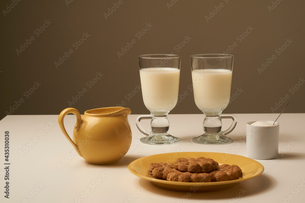Healthy fresh milk and cookies, on white table and dark background. Healthy fresh milk and cookies, on white table and dark background.