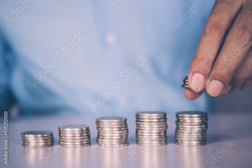 Hands of businessman put coin stack with increase growth, finance and saving, investment for profit and success, planning with financial, growing economy and fund, stock and income, business concept.