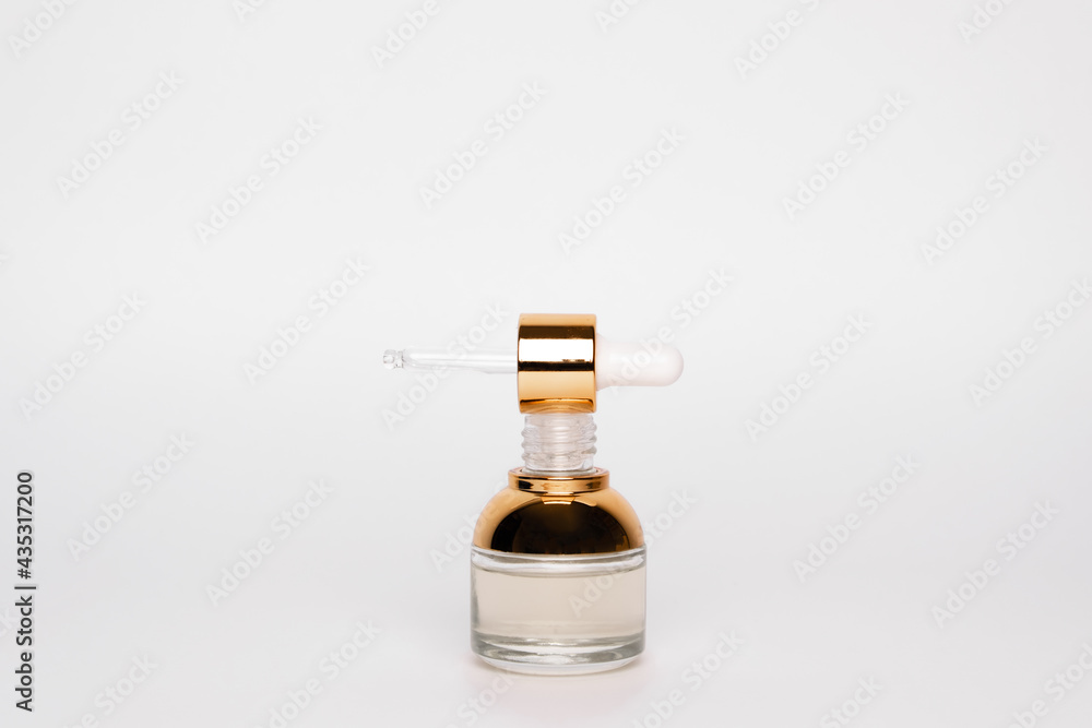 Transparent golden bottle with pipette and hylauronic acid. Top horizontal view copyspace Transparent golden bottle with pipette and hylauronic acid. Top horizontal view copyspace
