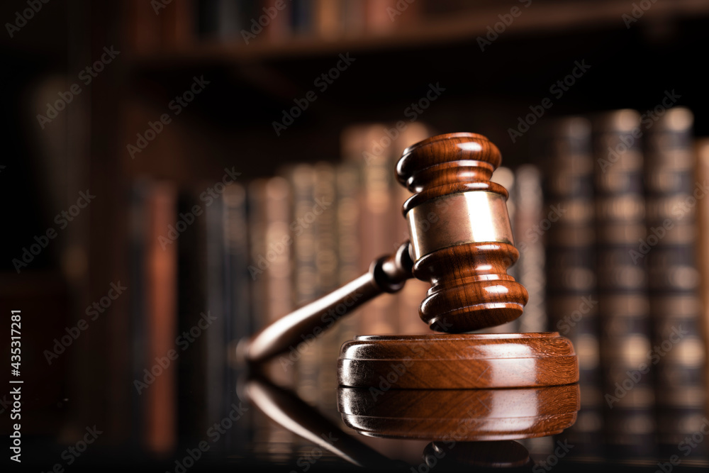 Law theme. Judge chamber. Judge’s gavel and collection of legal books in the bookshelf. Law theme. Judge chamber. Judge’s gavel and collection of legal books in the bookshelf.