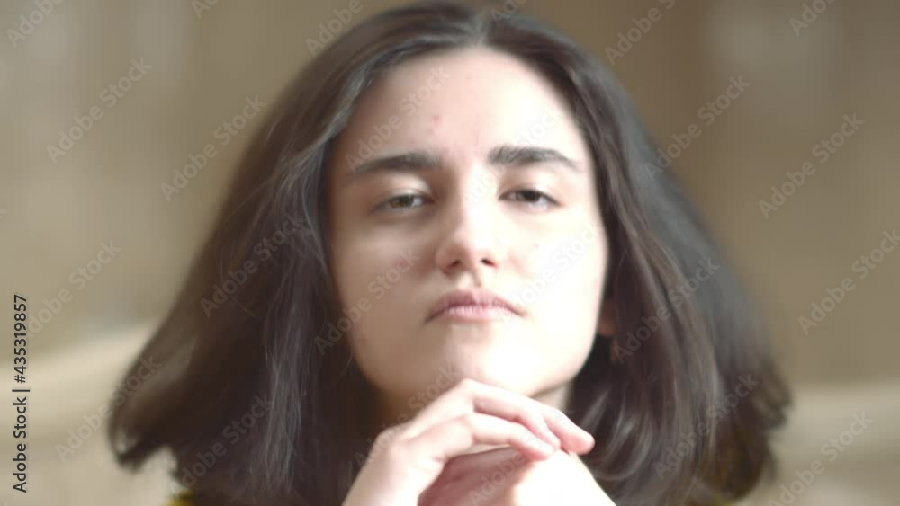 Portrait of a brunette girl looking directly at the camera Portrait of a brunette girl looking directly at the camera