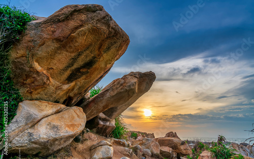 Abstract rocky beach with sunrise to greet the new day in the beautiful sea