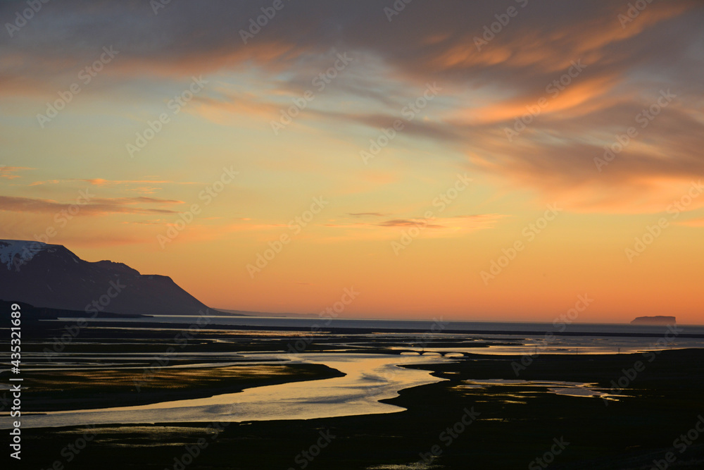 Fototapeta premium Beautiful midnight sunset over the marshes, cliffs, and bay near saudarkrokur, in northern Iceland 