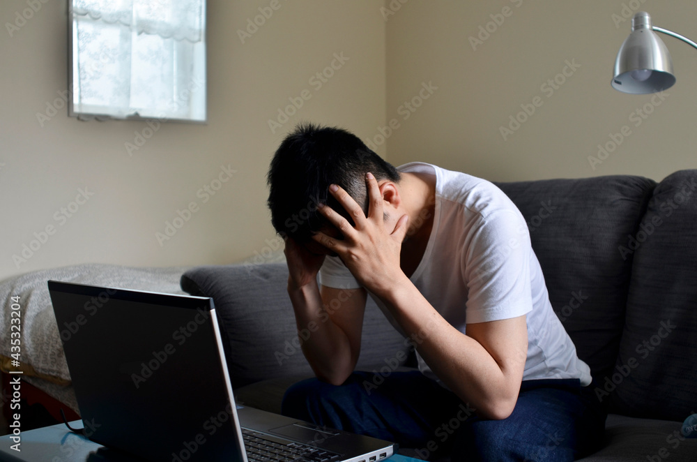 Frustrated Man with Head in Hands in Front of Laptop Frustrated Man with Head in Hands in Front of Laptop