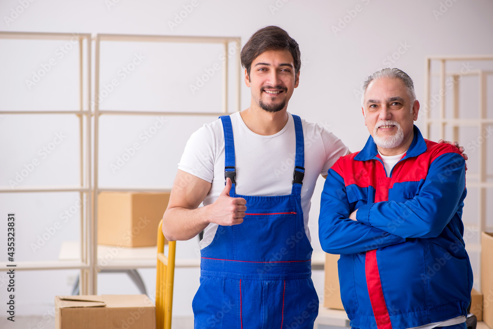 Two male professional movers doing home relocation Two male professional movers doing home relocation