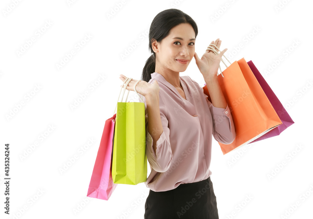 Portrait closeup isolated cutout shot of urban modern Asian young happy shopaholic female shopper smiling holding showing colorful paper shopping bags from department store in front white background Portrait closeup isolated cutout shot of urban modern Asian young happy shopaholic female shopper smiling holding showing colorful paper shopping bags from department store in front white background