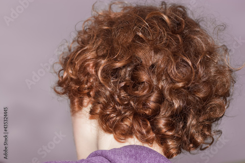 curly hair of medium length red color