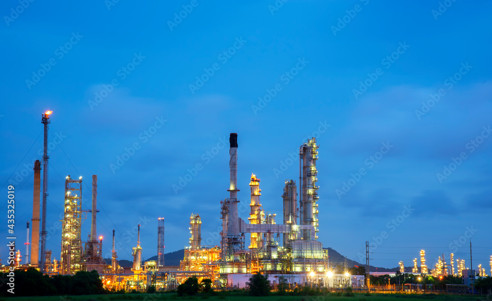 Oil refinery plant chemical factory and power plant with many storage tanks and pipelines at sunset. Oil refinery plant chemical factory and power plant with many storage tanks and pipelines at sunset.