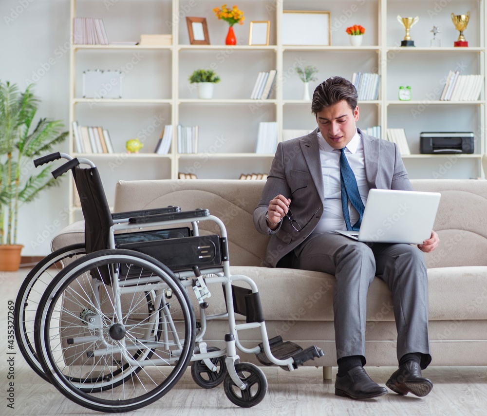 Dsabled businessman on wheelchair working home Dsabled businessman on wheelchair working home